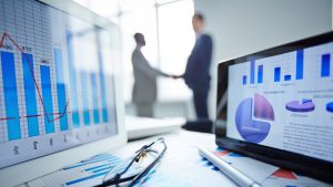 Business professionals reviewing performance analytics and growth charts on digital dashboards, representing affiliate marketing partnerships, campaign tracking, and revenue growth.